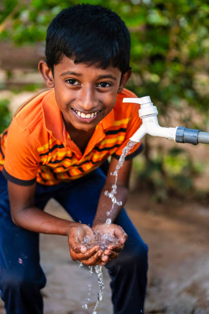 istock Sri Lankan young boy drinking a water, Ceylon 2205002388