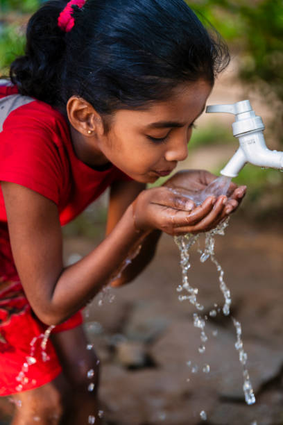 istock Sri Lankan young girl drinking a water, Ceylon 2205002409
