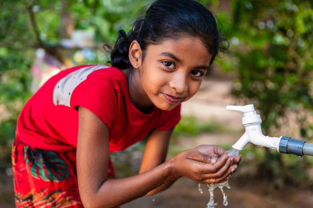 istock Sri Lankan young girl drinking a water, Ceylon 2205002448