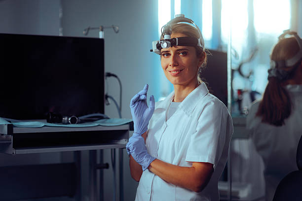 istock ENT Doctor with Equipment on her Head Preparing for Consultation 2205002494
