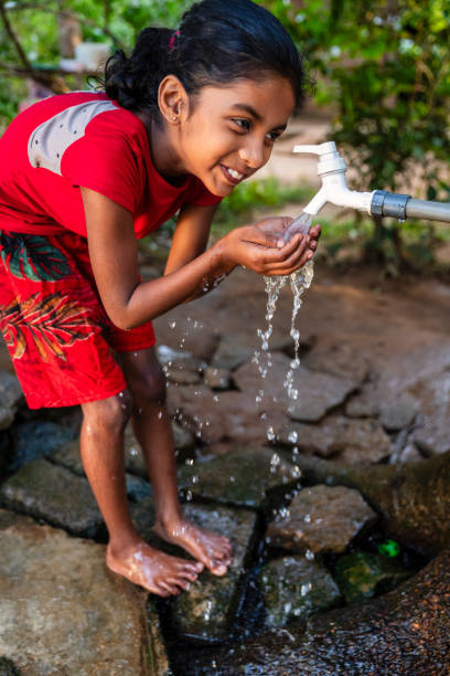 istock Sri Lankan young girl drinking a water, Ceylon 2205002503