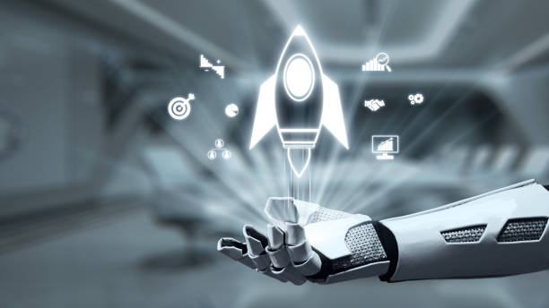 istock Futuristic robotic hand holding a digital rocket symbol with icons representing innovation, technology, and growth within a high-tech environment. Auvana 2205004817