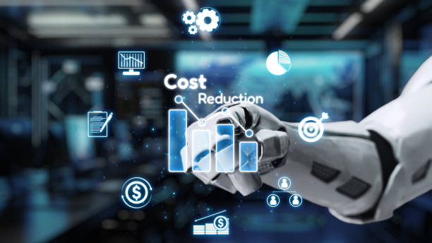 istock Futuristic robotic hand interacting with digital graphs and icons representing cost reduction in a high-tech office environment. Auvana 2205004854