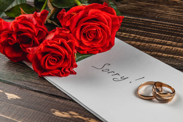 istock Expressing regret after a broken engagement with roses and wedding rings 2205006140