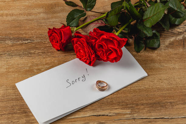 istock Broken engagement gesture with roses and a heartfelt apology note 2205006933