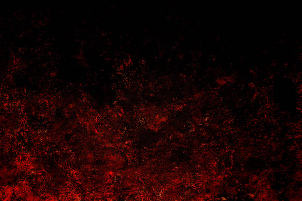istock gloomy background of red splashes on black 2205012407