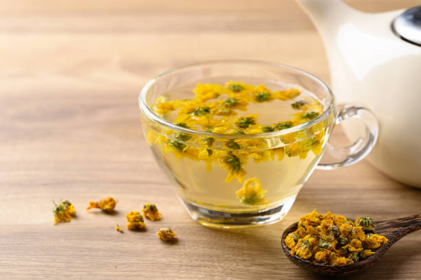Chrysanthemum tea in cup glass with dried Chrysanthemum flowers, Healthy herbal drink