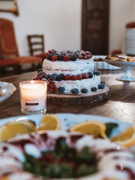 istock Burning candles and cake decorated with fresh berries 2205013342
