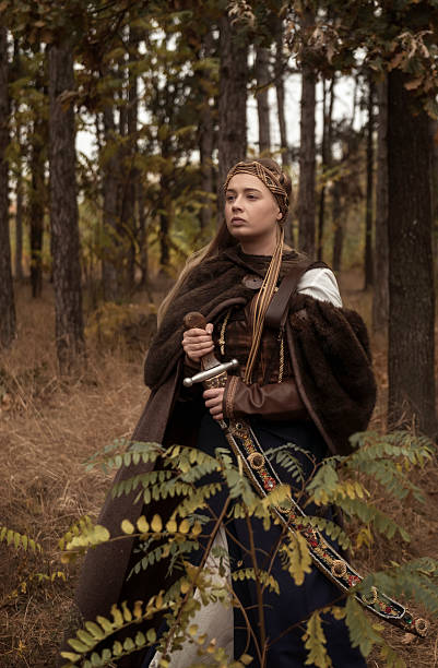 istock warrior girls with sword in hands in autumn forest. 2205015720