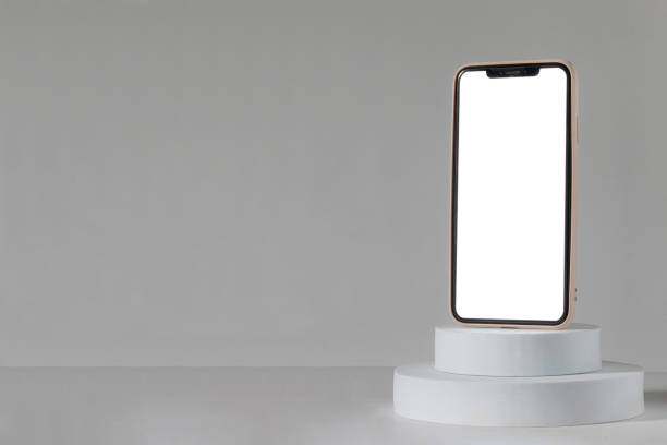 istock A phone is sitting on a white pedestal. The phone is turned off 2205016916