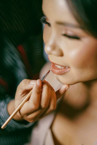 istock Close-Up of Bride Getting Lipstick Applied Before Wedding by a Make-Up Artist Using Brush 2205018575