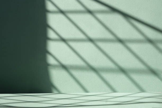 istock Light on wall. Green minimalistic background. Wallpaper. Overlay mock up effect. Mockup for presentations, backgrounds. Shadow drop and rays of light on green surface. 2205019621