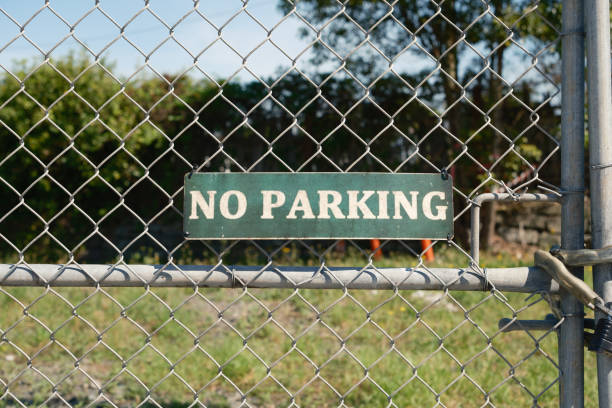istock Green No parking sign on a metal gate 2205021802