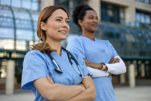 istock Two confident female doctors smiling outside hospital 2205021842