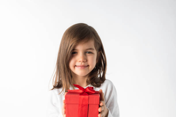 istock Smiling Girl Holding a Red Gift Box 2205021893
