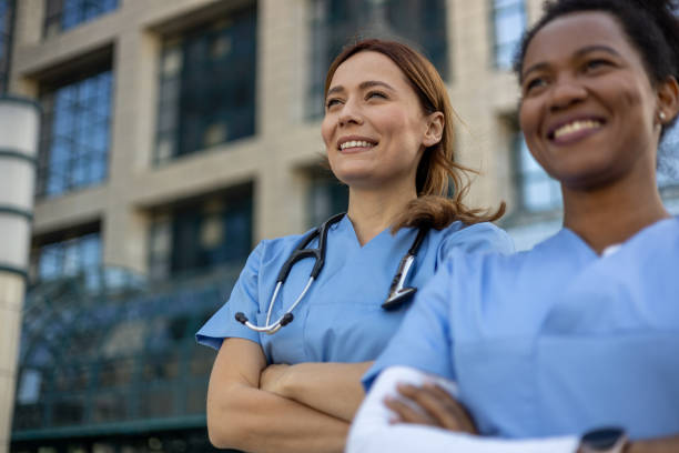 istock Two smiling female doctors looking up with hope 2205021904