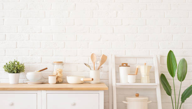istock Home kitchen decor concept with utensils, bowls and jars on white brick wall background 2205022921