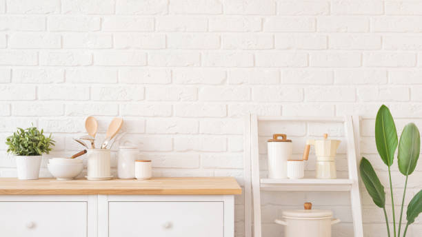 istock Utensils, containers and bowls on wooden kitchen cabinet surface and shelf over white brick wall background 2205022934