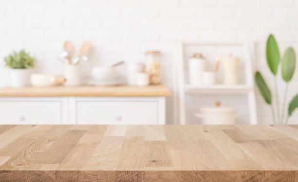 istock Wooden table surface for presentation on blurred kitchen room interior background 2205022945