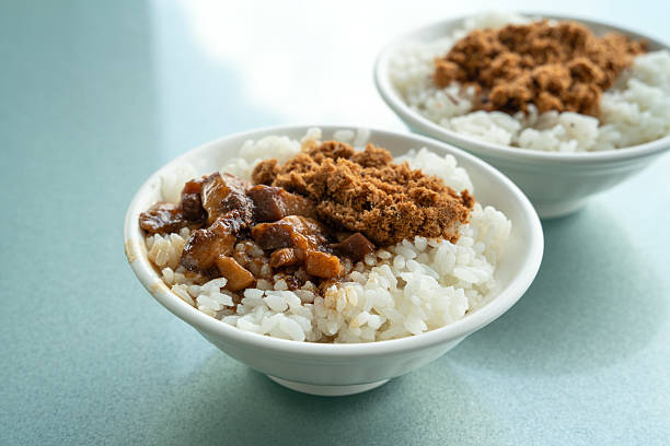 Braised pork belly meat rice, stewed pork over cooked rice with pan-fried milkfish beside.