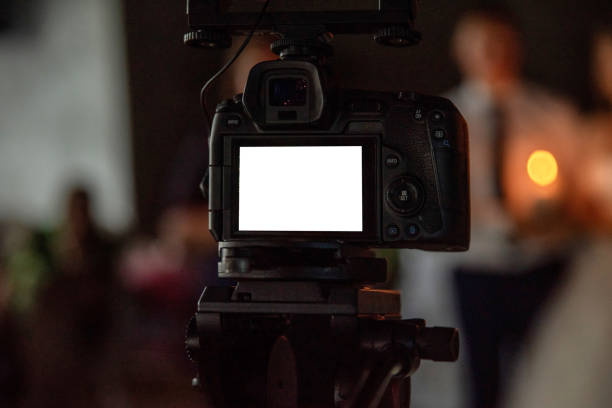 istock Professional camera recording wedding scene on tripod 2205024378