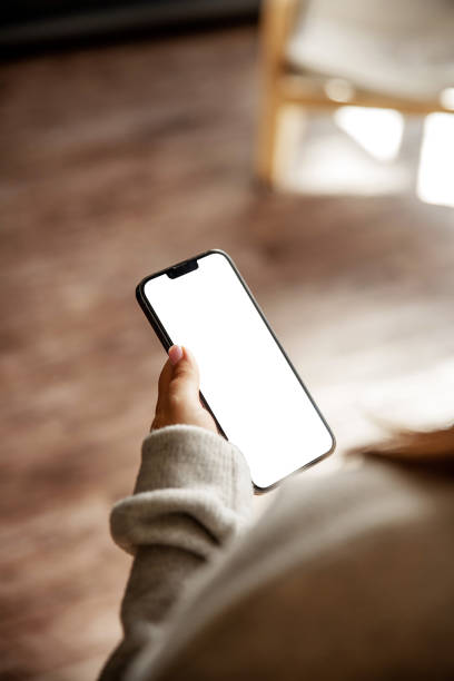 Woman's hand holding a smartphone with a blank white screen