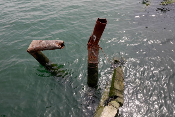 istock broken steel pipe in the water 2205026564