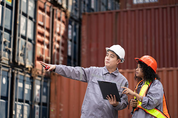 istock Asia supervisor worker man and woman working with checking container at container site 2205027487