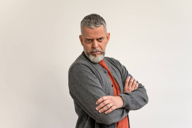 istock Confident Mature Man in Gray Cardigan with Intense Expression 2205028276