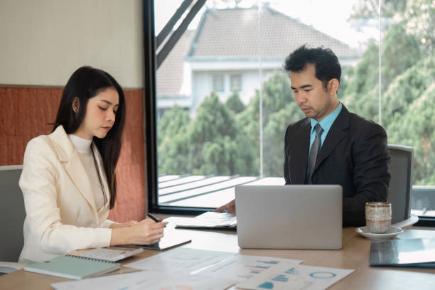 istock Business partners analyzing financial data and discussing strategies in a bright office environment. 2205029611