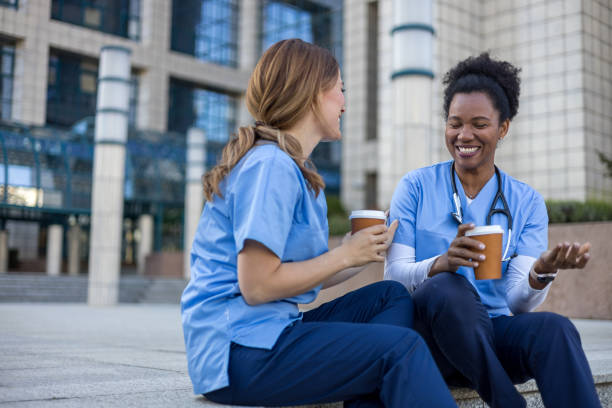 istock Two nurses taking a break and chatting outside hospital 2205029945