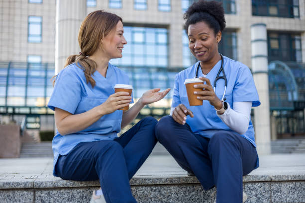 istock Two nurses enjoying coffee break outside hospital 2205029985