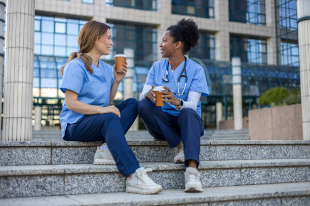 istock Two nurses enjoying coffee break outside hospital 2205029994