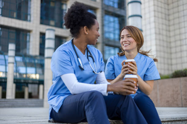 istock Two nurses enjoying coffee break outside hospital 2205030036