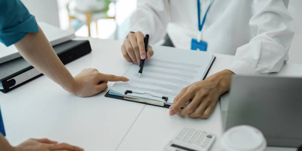 istock Close-up of hands discussing documents in a collaborative office meeting. 2205031873