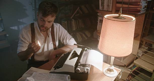 istock A Vintage Writer is Working Late at Night, Diligently Typing on a Classic Typewriter 2205035257