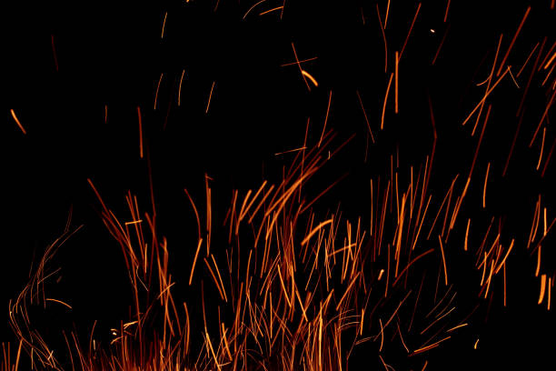 sparks from the fire glowing in the dark