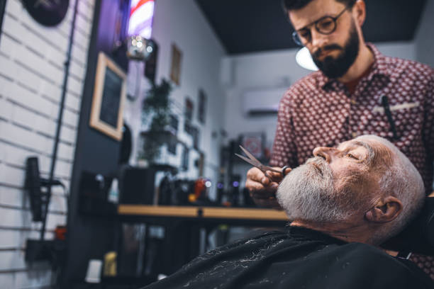 istock Senior man cutting his beard in barbershop 2205036242