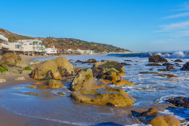 istock Rocky Shoreline at Malibu Beach with Coastal Homes 2205036632