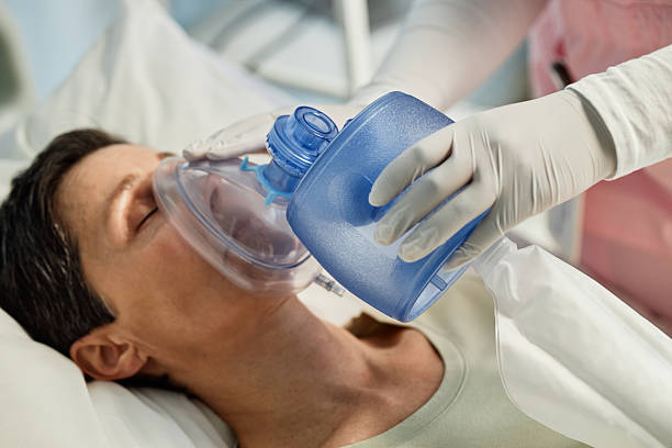 istock Providing Oxygen Support to a Patient in Hospital Setting 2205038548