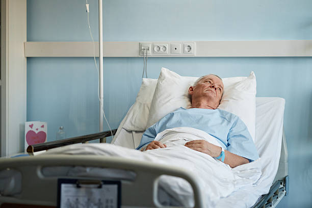 istock Recuperating Elderly Patient Resting in Hospital Bed 2205038618