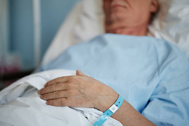 istock Resting Patient Hand With Medical Wristband 2205038624