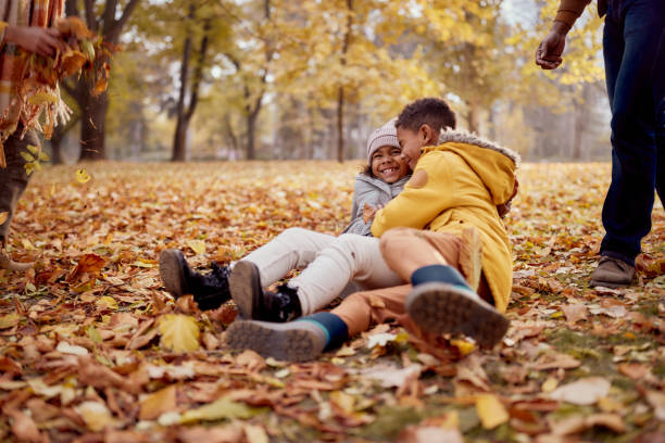 istock Happy black siblings having fun during autumn day in nature. 2205040681
