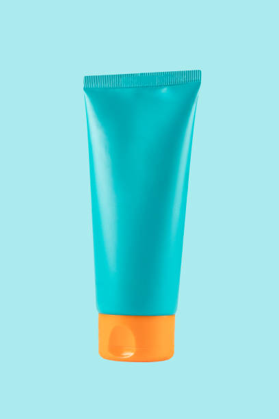istock Sunscreen protection lotion bottle isolated on cyan background 2205041356