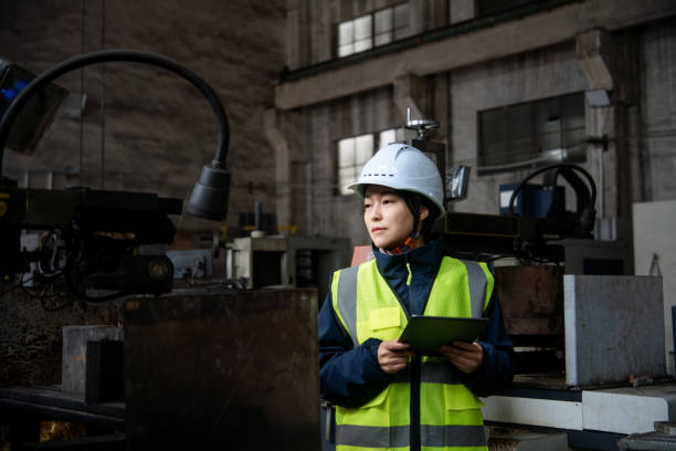 istock asian female engineer working with digital tablet in metal processing factory 2205041566