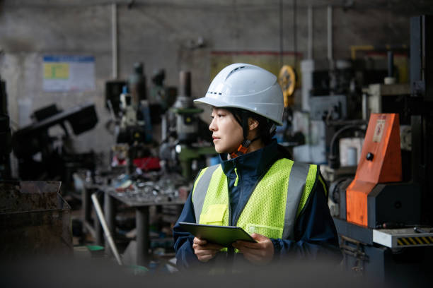 istock asian female engineer working with digital tablet in metal processing factory 2205041602