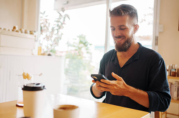 istock A man is enjoying a delicious cup of coffee while using his smartphone in a cozy cafe atmosphere 2205042388