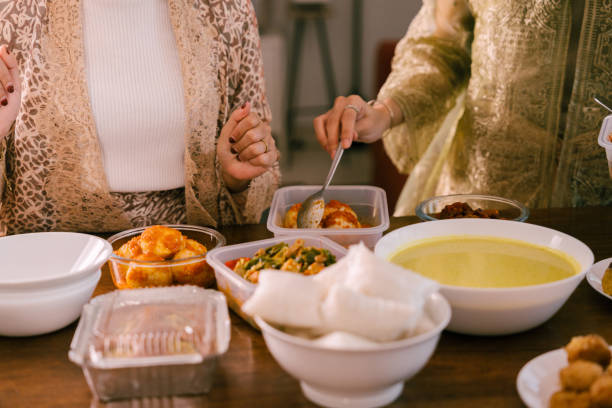 istock Young Beautiful Woman Preparing Food For Eid Mubarak 2205043705