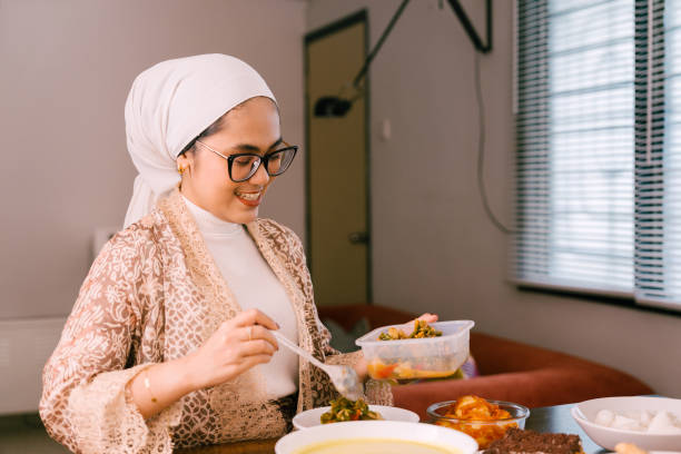 istock Young Beautiful Woman Preparing Food For Eid Mubarak 2205044182