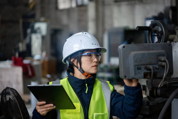 istock Asian female engineers operate  CNC 2205044588